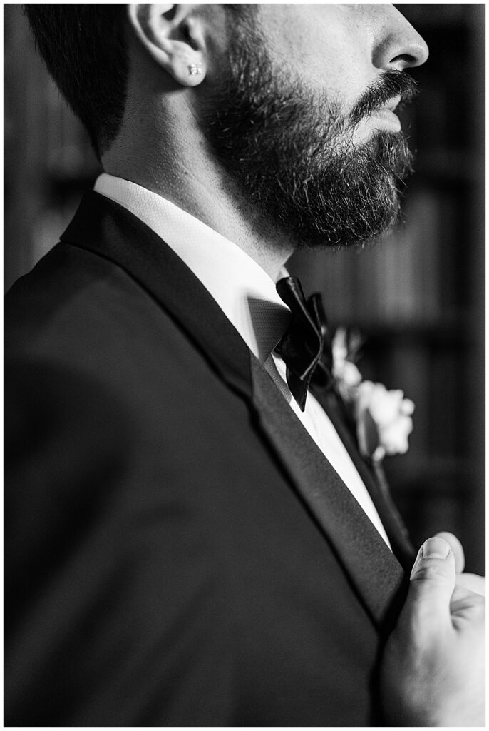 A groom poses for a close-up profile photo while getting ready for his Virginia House wedding in Richmond in the fall. Photo by a Richmond wedding photographer, Emily Nicole Photography.