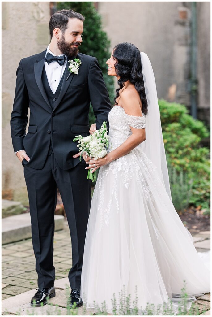 A bride and groom pose for newlywed portraits at Virginia House in Richmond, serving as their enchanting, fairytale estate wedding venue. Photos by a Richmond wedding Photographer, Emily Nicole Photography.