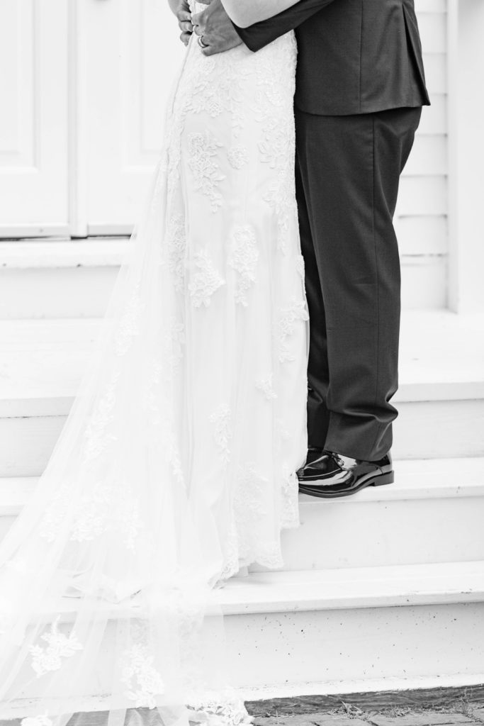 black and white wedding photo, wedding dress, black suit, b&w, detail shot, wedding details, first look image