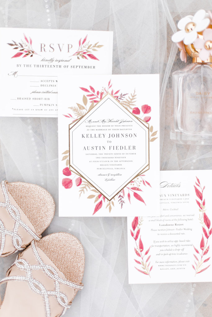 burgundy and gold wedding invitations flatlay with gold sparkly bridal shoes and Daisy Jacobs perfume