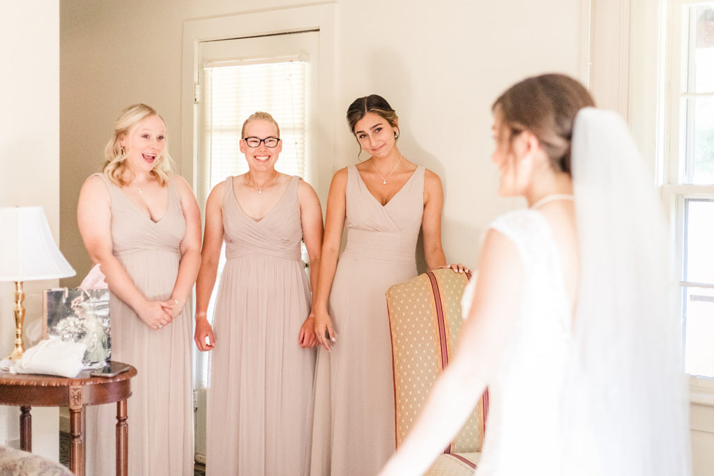 How to choose your bridesmaids without hurting anyone's feelings. A bride has a First Look with her bridesmaids. Taken in black and white by a Virginia wedding photographer.
