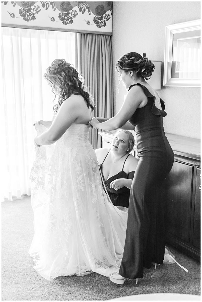 DMV wedding photographer, black and white bride getting in the dress photo, bridal suite 