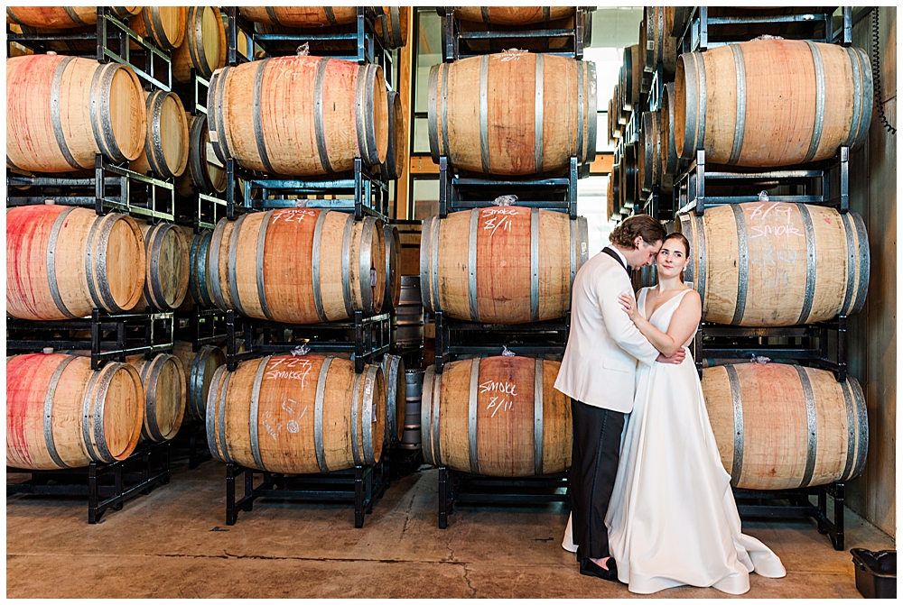 District Winery wedding photos in the production facility with the wine barrels. Washington, D.C. wedding photographer.