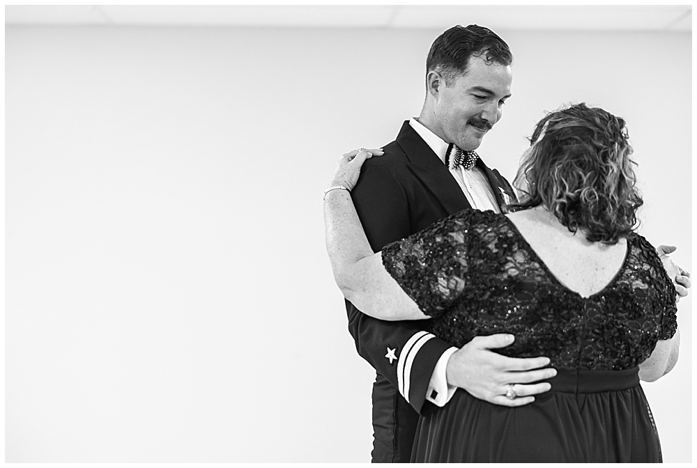 Navy servicemember groom shares a Mother-Son dance after his traditional Catholic wedding ceremony at Basilica School of Saint Mary in Washington, D.C. | Photo taken by D.C. wedding photographer