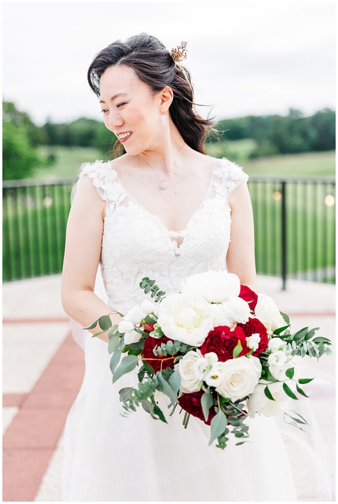 Bridal portrait of Asian American bride holding white and red bridal bouquet at her Congressional Country Club wedding in Bethesda, MD | DMV Wedding Photographer