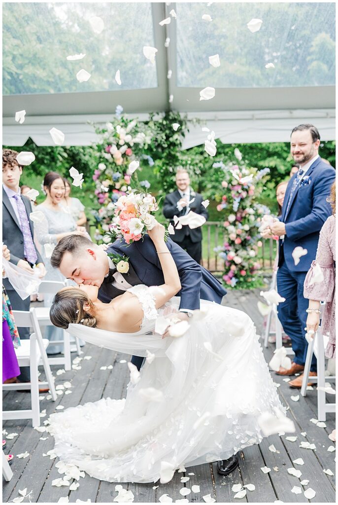Bride and groom walk down the aisle as husband and wife at their tent covered ceremony with petal toss | The Manor at Airmont wedding | Northern VA Wedding Photographer