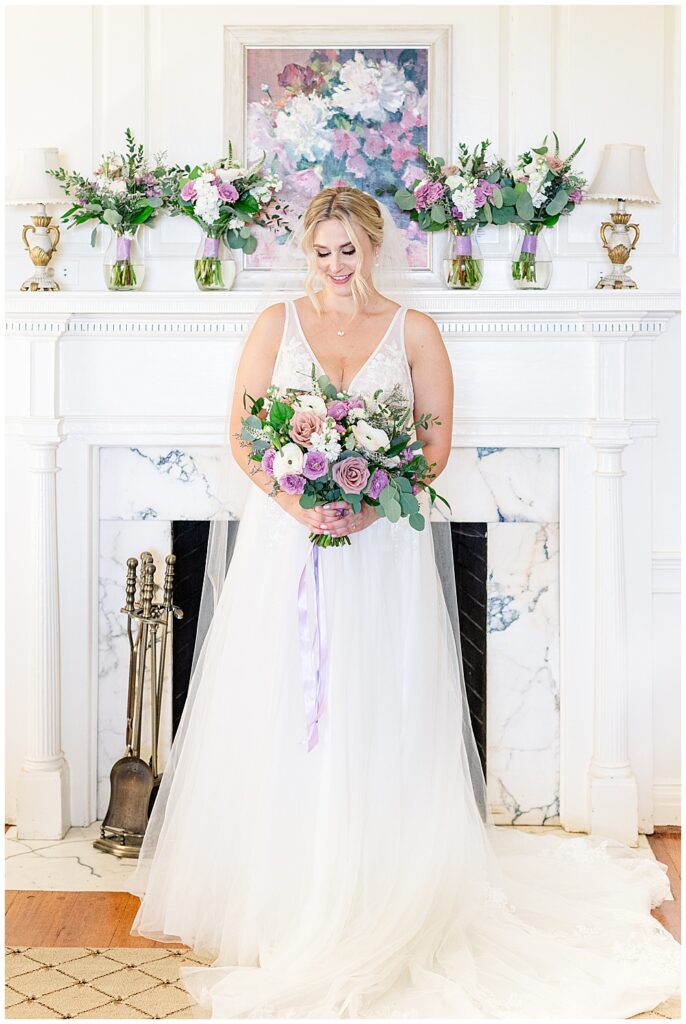 Bride holds her fluffy, pastel lavender bridal bouquet with eucalyptus, wearing a floor length veil and tulle ballgown wedding dress

River Farm Wedding | Alexandria Wedding Photographer