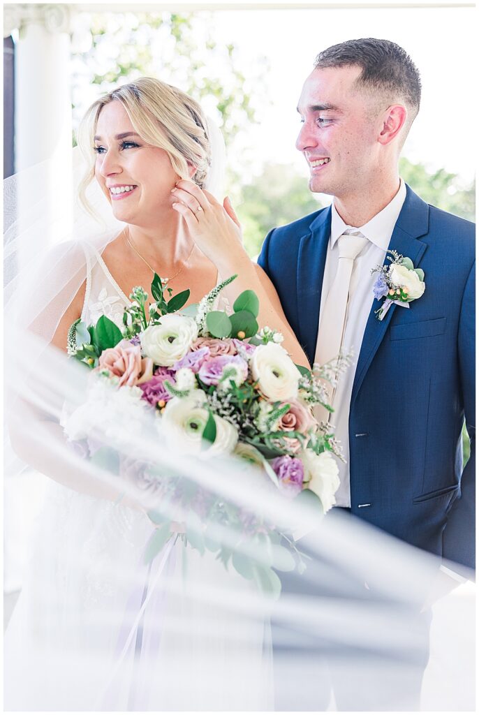 Bride and groom pose together with a swooping floor-length veil and lavender bridal bouquet

River Farm Wedding | Alexandria Wedding Photographer