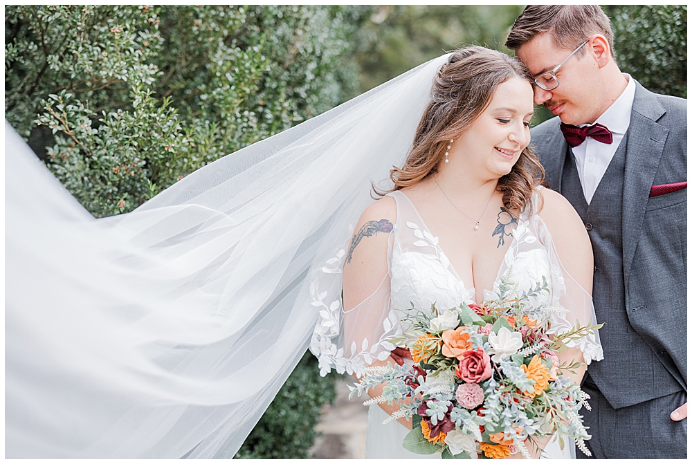 A close-up shot of a bride and groom with their heads nestled together, smiling. The bride's long veil is swooping off to the side of the frame.

Rust Manor House Wedding | Leesburg Wedding Photography | VA Wedding Venues
